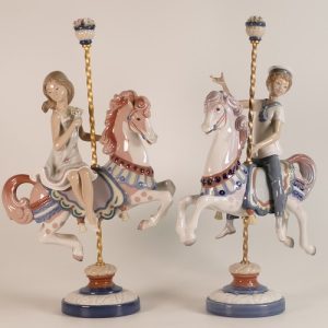 Lladro, pair of figures of a boy and girl on Carousel horses Nos. 1469, & 1470.
